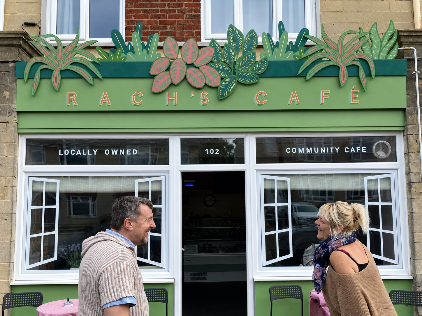 People outside the green botanical shopfront of Rach’s Café