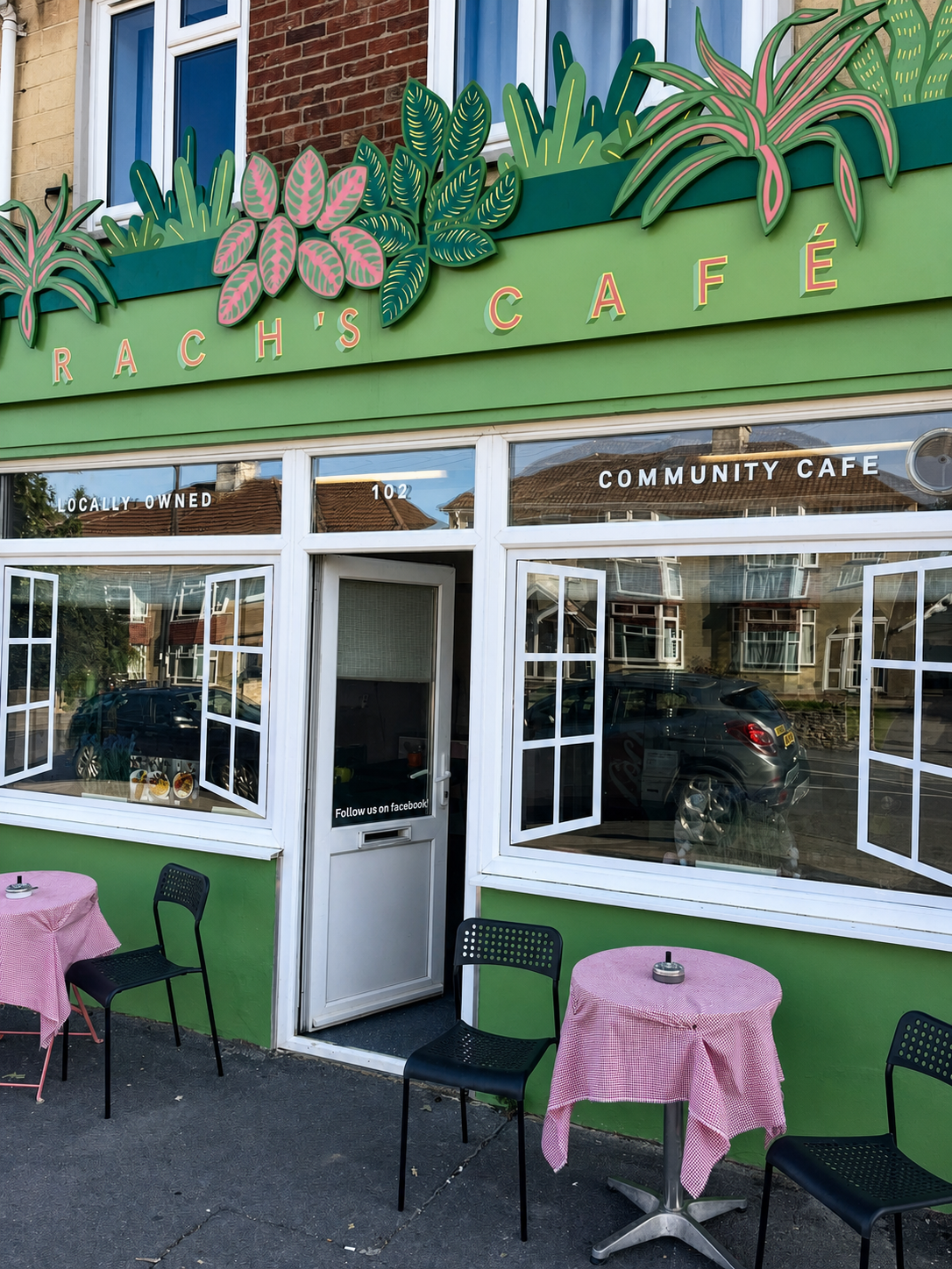 The green botanical shopfront and outdoor café tables at Rach’s Café